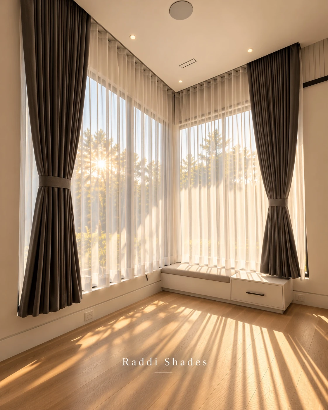 Layered charcoal drapes and luminous sheers in a sunlit residential corner